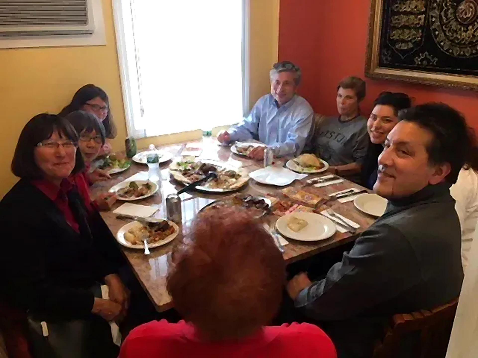 Guests gathered around a table with plates