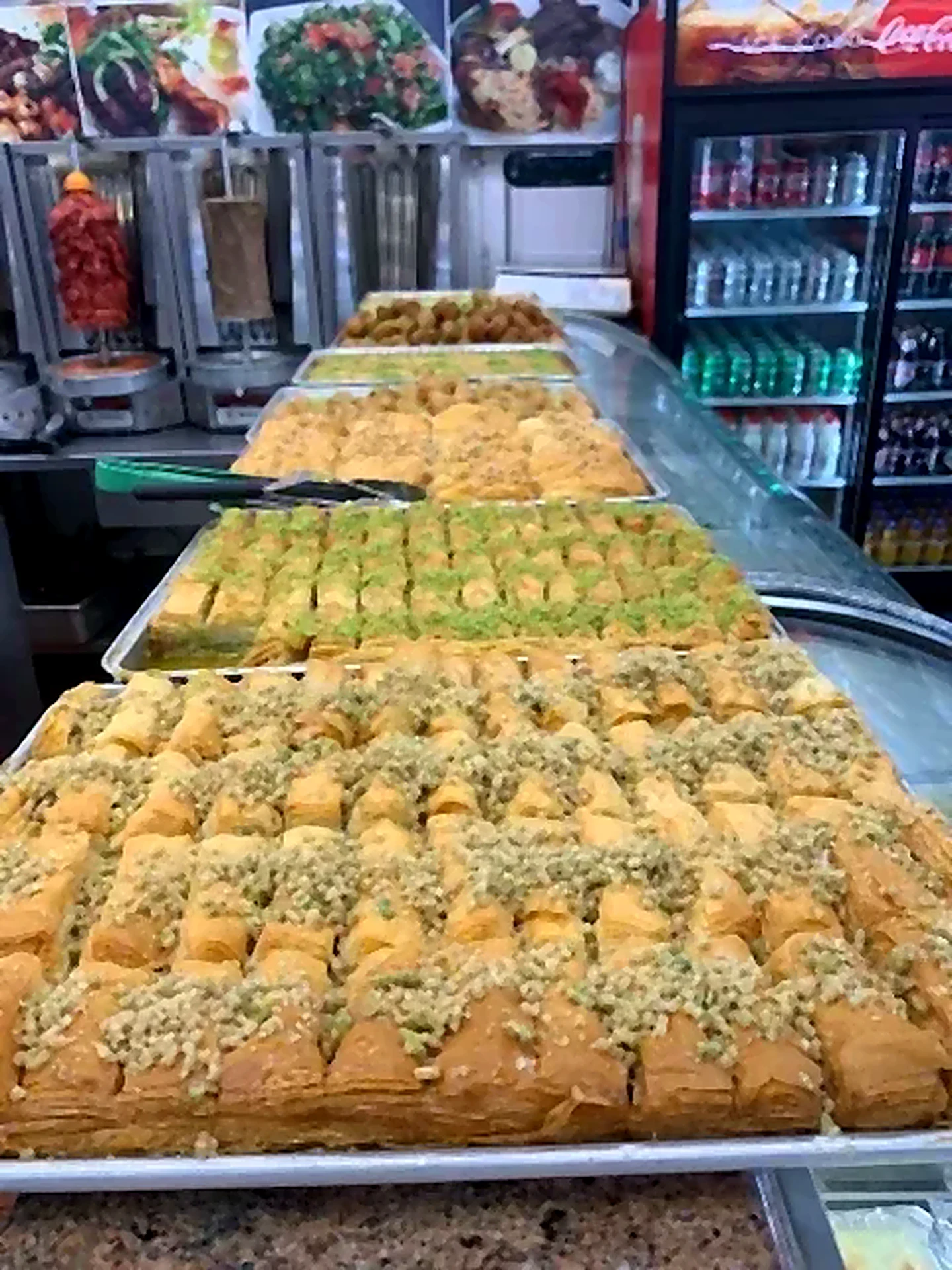 Counter with baklava trays and drink coolers