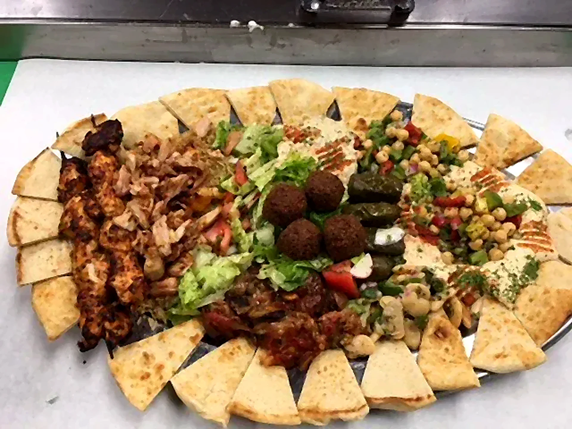 Round catering platter ringed with pita