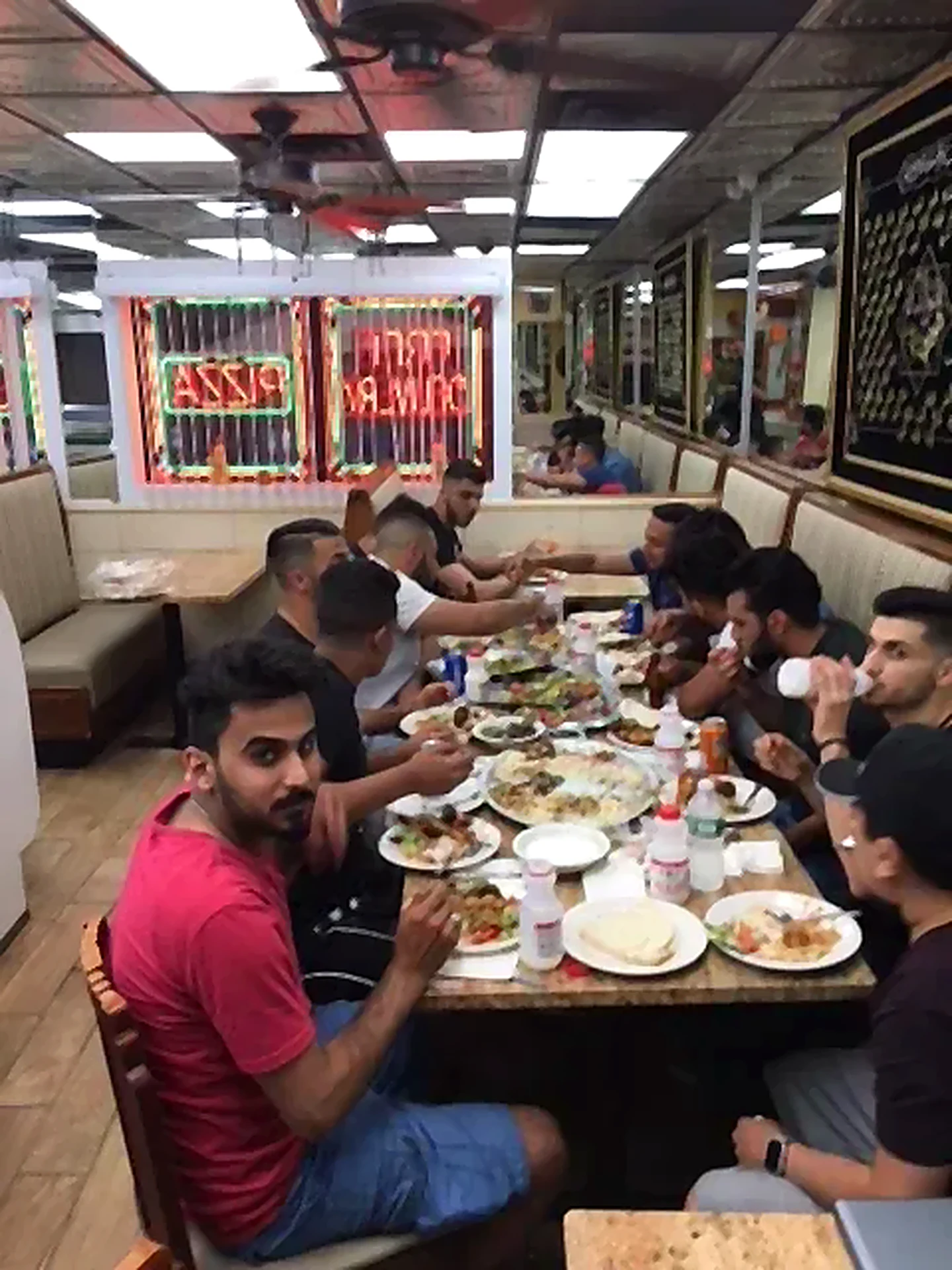 A group of guests eating together at a long table