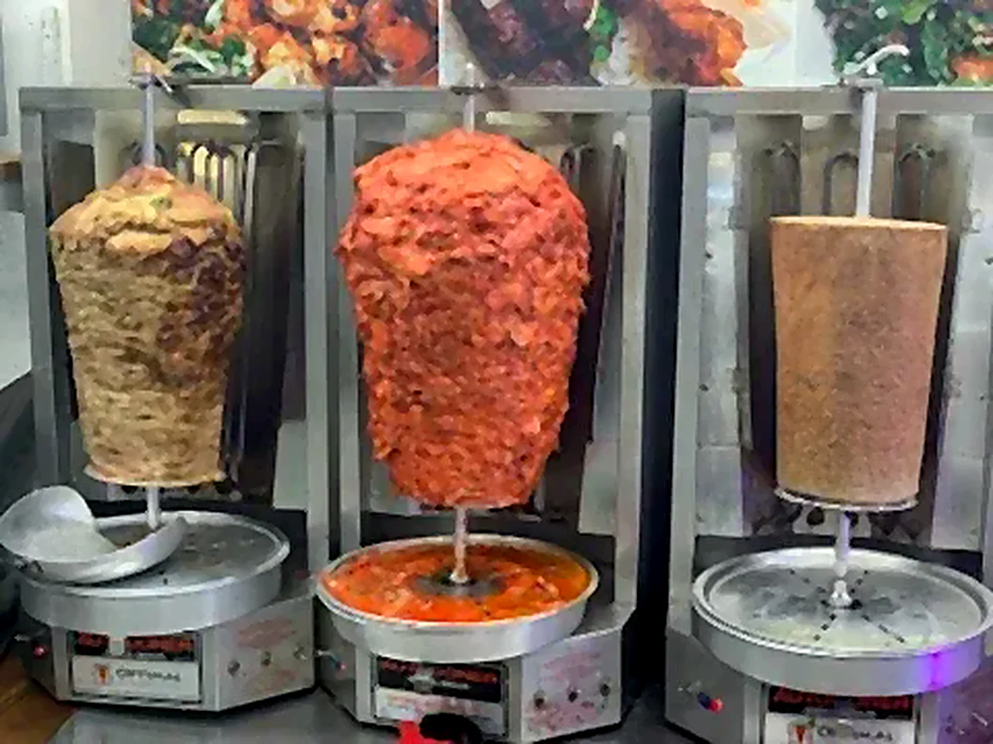 Three vertical shawarma spits