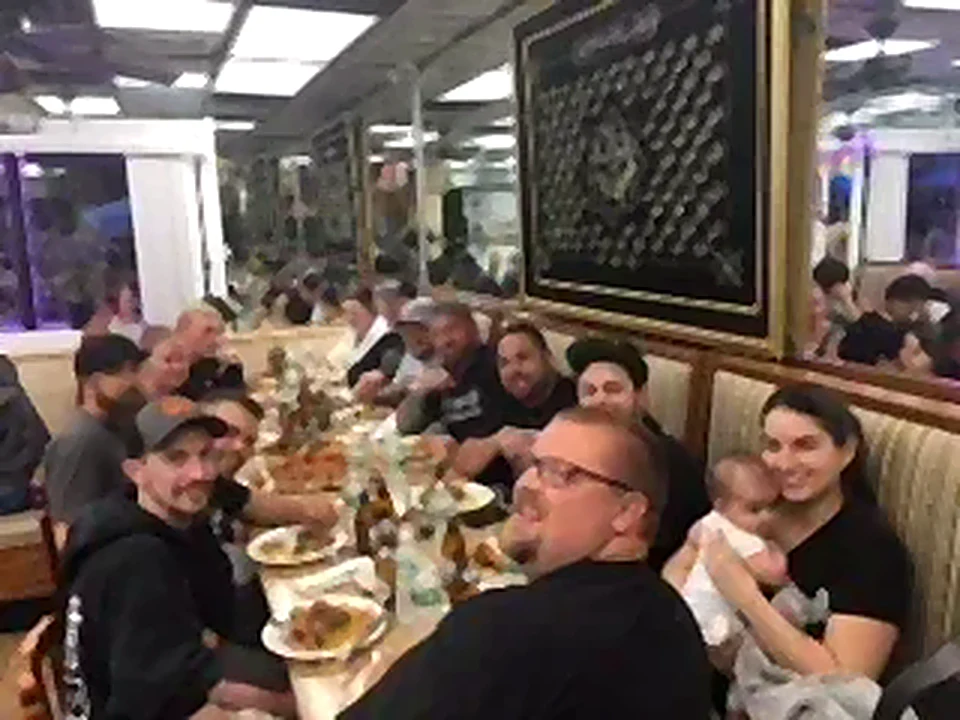 Guests sharing a meal at a long table in the dining room