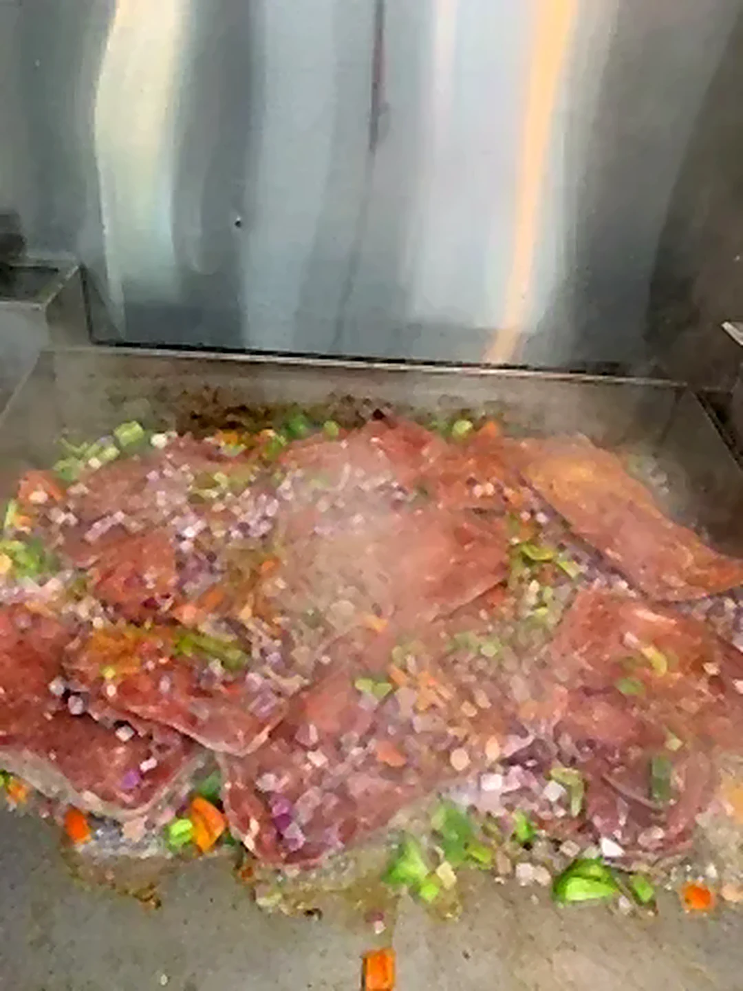 Meat and vegetables on a flat-top grill