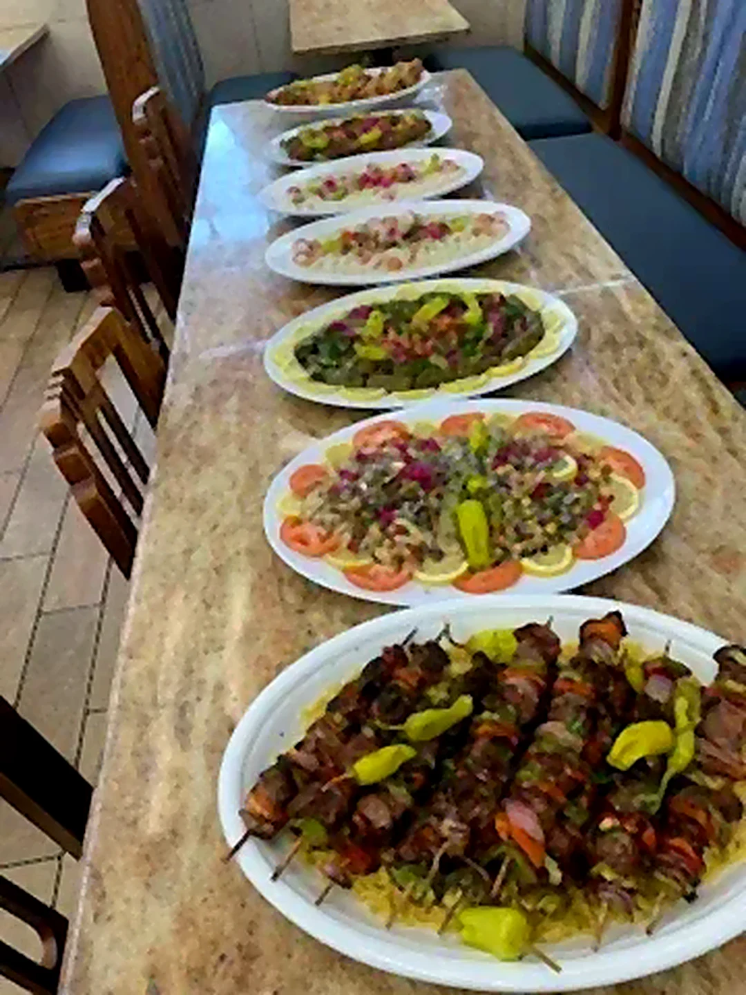 Long table set with plates beside the booths