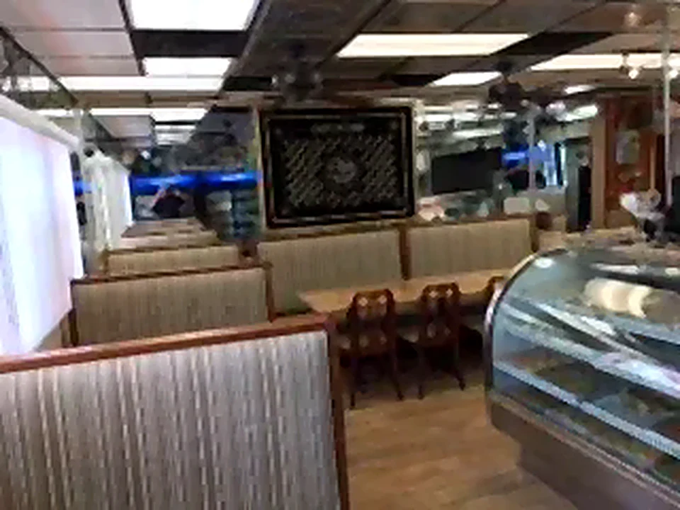 Dining room with booths, tables and a glass display case
