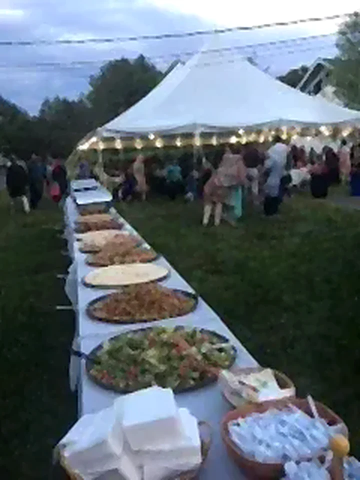 Outdoor tent event with a long buffet table
